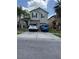 Two-story home featuring a two-car garage, neutral color palette, and a spacious driveway at 2753 Monticello Way, Kissimmee, FL 34741