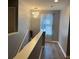 Hallway featuring modern chandelier, hardwood floors, and natural light from a window at 2753 Monticello Way, Kissimmee, FL 34741