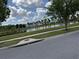 Community pond featuring grassy area and walking path with views of nearby apartments at 2753 Monticello Way, Kissimmee, FL 34741