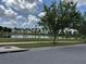 Community pond featuring grassy area and walking path with views of nearby apartments at 2753 Monticello Way, Kissimmee, FL 34741
