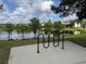 Community pond view featuring a bike rack on a concrete foundation near grassy area at 2753 Monticello Way, Kissimmee, FL 34741