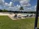 Community pool area with lounge chairs and a beautiful manicured lawn at 2753 Monticello Way, Kissimmee, FL 34741