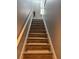 Stairway featuring hardwood steps and railings, leading up to the next level of the home at 2753 Monticello Way, Kissimmee, FL 34741