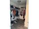 Walk-in closet features clothing racks with an assortment of items and hardwood flooring for an organized, stylish look at 2753 Monticello Way, Kissimmee, FL 34741