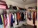 Walk-in closet features organized clothing racks and flooring, providing an organized, stylish storage solution at 2753 Monticello Way, Kissimmee, FL 34741