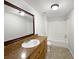 Bathroom features a vanity with storage, mirror, and shower-tub combo with tile surround at 2845 Ellis Ave, Lakeland, FL 33803