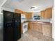 Well-lit kitchen with wooden cabinets, modern appliances, and vinyl flooring at 2845 Ellis Ave, Lakeland, FL 33803