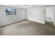 Vacant living room with neutral carpet, fresh paint, and natural light from a window near the front door at 2845 Ellis Ave, Lakeland, FL 33803
