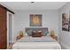 Spacious bedroom featuring a modern sliding barn door, king-sized bed and art at 3254 Oak Lake Pl # 137, Winter Park, FL 32792