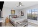 Bright bedroom featuring a ceiling fan, large window, and contemporary decor with art at 3254 Oak Lake Pl # 137, Winter Park, FL 32792