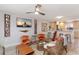 Bright living room with modern ceiling fan, stylish decor, and seamless flow to the kitchen area at 3254 Oak Lake Pl # 137, Winter Park, FL 32792