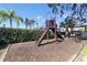 Community playground featuring a slide, stairs, and protective mulch ground cover at 3254 Oak Lake Pl # 137, Winter Park, FL 32792
