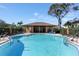 Community pool with a relaxing atmosphere, mature trees, and comfortable seating areas at 3254 Oak Lake Pl # 137, Winter Park, FL 32792