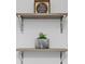 Floating shelves with metal supports and modern decorations at 3254 Oak Lake Pl # 137, Winter Park, FL 32792