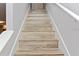 Stairway featuring wood-look treads and white risers at 3254 Oak Lake Pl # 137, Winter Park, FL 32792