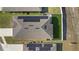 An aerial view of the home features solar panels, manicured lawn, and a fenced backyard at 3532 Yarian Dr, Haines City, FL 33844