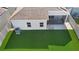Aerial view of the backyard, showcasing the artificial turf and screened-in patio of this well-maintained property at 3532 Yarian Dr, Haines City, FL 33844