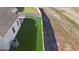 Aerial view of backyard with artificial turf, offering a maintenance-free outdoor space with privacy fencing at 3532 Yarian Dr, Haines City, FL 33844