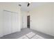 Bedroom with carpet, fan, and closet featuring double doors at 3532 Yarian Dr, Haines City, FL 33844