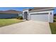 A one-story home has a manicured lawn, blue shutters, and a two-car garage at 3532 Yarian Dr, Haines City, FL 33844