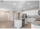This expansive kitchen features a center island with granite countertops, stainless appliances and white cabinets at 3532 Yarian Dr, Haines City, FL 33844