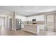 Modern kitchen offers stainless steel appliances, granite counters, white cabinets, and an island at 3532 Yarian Dr, Haines City, FL 33844