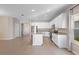 Bright kitchen with white cabinets, stainless appliances, granite counters, and an island open to a living area at 3532 Yarian Dr, Haines City, FL 33844