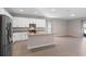 Open kitchen boasts stainless steel appliances, granite countertops, an island, and ample natural light at 3532 Yarian Dr, Haines City, FL 33844