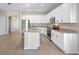 Open kitchen featuring an island with granite counters, stainless appliances, and white cabinets at 3532 Yarian Dr, Haines City, FL 33844