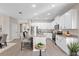 Bright kitchen with white cabinetry, granite countertops, stainless steel appliances, and an island with bar seating at 3532 Yarian Dr, Haines City, FL 33844