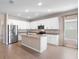 Modern kitchen boasts white cabinets, stainless steel appliances, granite countertops, and a central island at 3532 Yarian Dr, Haines City, FL 33844
