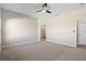 Bright carpeted main bedroom features a ceiling fan and an attached bathroom entrance at 3532 Yarian Dr, Haines City, FL 33844