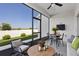 Relaxing screened patio with outdoor seating, a ceiling fan, and views of the fenced backyard at 3532 Yarian Dr, Haines City, FL 33844