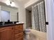Bright bathroom features a shower-tub combination with a decorative shower curtain at 377 Blue Bayou Dr, Kissimmee, FL 34743