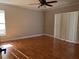 Bedroom with ceiling fan, wood-look floors, and sliding glass doors at 377 Blue Bayou Dr, Kissimmee, FL 34743