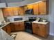 Well-equipped kitchen with granite countertops, stainless steel appliances, and tile backsplash at 377 Blue Bayou Dr, Kissimmee, FL 34743