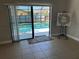 Indoor view through sliding glass doors looking out to a private screened-in pool and patio area at 377 Blue Bayou Dr, Kissimmee, FL 34743