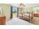 Cozy bedroom featuring a wooden bed frame, window with curtains, and neutral walls at 3823 Martin St, Orlando, FL 32806