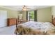 Bedroom with a floral patterned bed, dresser, and window with natural light at 3823 Martin St, Orlando, FL 32806