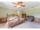 Bedroom with a wooden bed frame, side tables, and ceiling fan at 3823 Martin St, Orlando, FL 32806