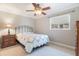 Bedroom with metal framed bed, side table and neutral wall color, enhanced by natural light at 3823 Martin St, Orlando, FL 32806