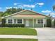 Charming single-story home featuring a well-manicured lawn and classic design under a sunny sky at 3823 Martin St, Orlando, FL 32806