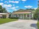 Well maintained single-story home featuring tidy landscaping, an expansive driveway, and a welcoming façade at 3823 Martin St, Orlando, FL 32806