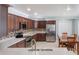 Bright and open kitchen featuring stainless steel appliances, wood cabinets and a cozy dining area at 3823 Martin St, Orlando, FL 32806