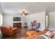 Bright living room with hardwood floors, a large TV, and comfortable leather furniture at 3823 Martin St, Orlando, FL 32806