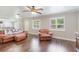 Open living room with hardwood floors, a pass-through to the kitchen, and comfortable seating at 3823 Martin St, Orlando, FL 32806