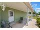 Cozy covered patio with a seating area, perfect for relaxing outdoors at 3823 Martin St, Orlando, FL 32806