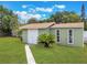Rear yard showing storage shed with white doors, matching house trim and landscaping at 3823 Martin St, Orlando, FL 32806