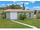 Rear yard showing storage shed with white doors, matching house trim and landscaping at 3823 Martin St, Orlando, FL 32806