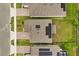 Aerial view of rooftops showing solar panels and green lawns between houses and brick paver driveways at 4216 Jespersen St, Apopka, FL 32712